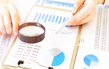 magnifying glass over different graphs 