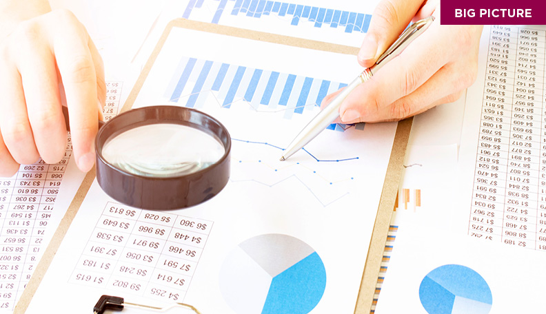 magnifying glass over different graphs 