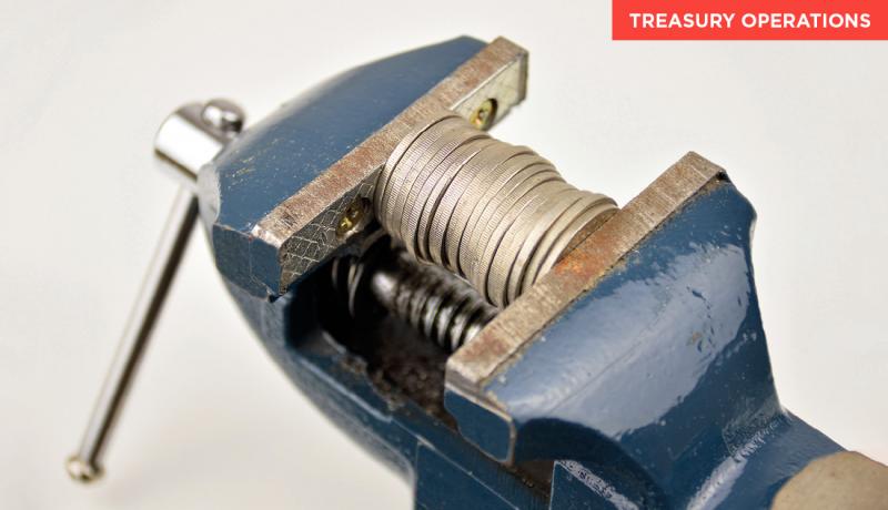 Coins being held in a vice