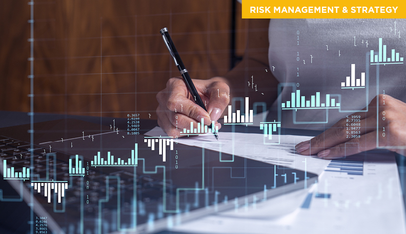 Woman writing with graphs showing rise and fall