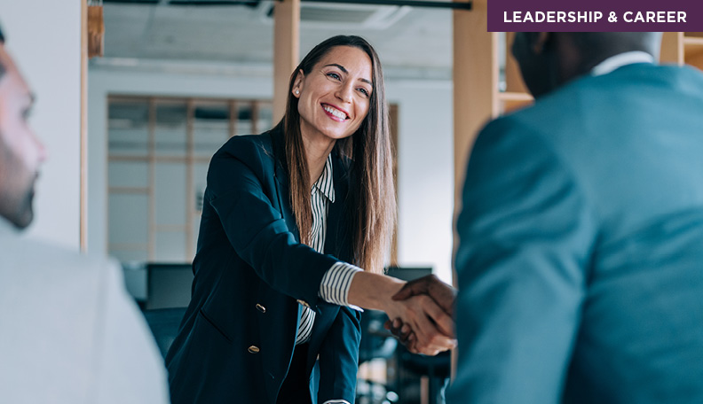 Businesswoman shakes hand with businessman