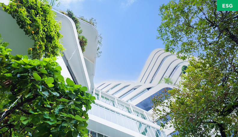 Skyscraper reaching into the sky with green plants covering it