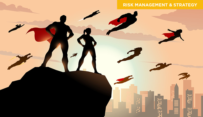 Superheroes in capes standing on a cliff