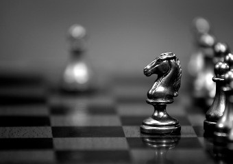 black and white photo of a chess game in progress