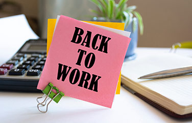 Image of a note on a desk reading: ‘back to work