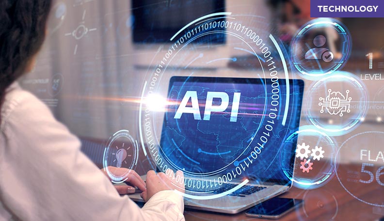 Image of a woman working on a laptop that has ‘API’ on its screen