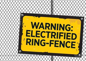 Yellow sign on fence, reading ‘Warning: electrified ring-fence’