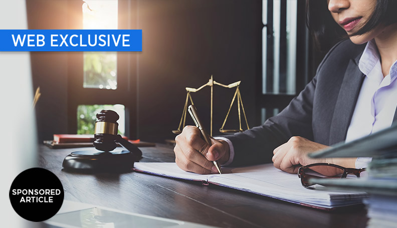 Image of a woman at a desk with a gavel and scales beside her