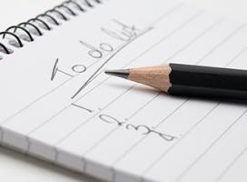 Image of a close-up of a to-do list on a notepad and with a pencil