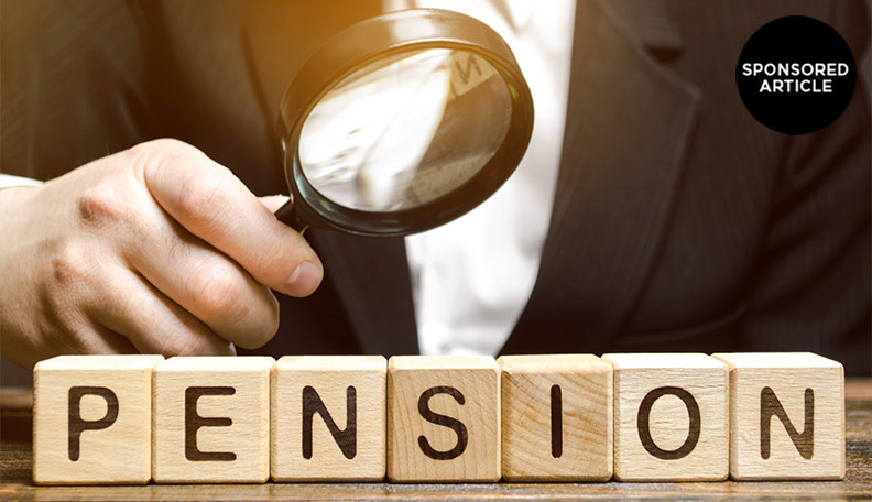 Image of a person holding a magnifying glass over wooden blocks that spell out ‘pension’