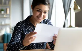 A student sitting at their desk, receiving their assessment feedback