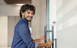 Man opening the door, concept showing him moving toward future career opportunities