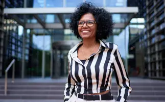 Woman smiling. Representing the treasury eLearning First Steps in Treasury course, Being a Treasurer