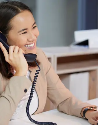 Woman on the phone, helping a student who is calling