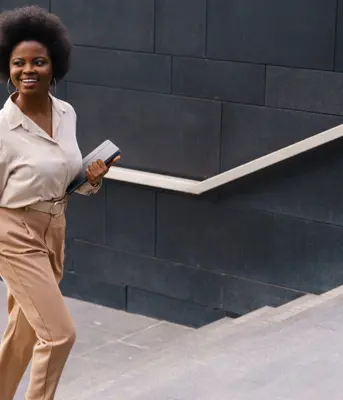 Treasury professional walking up a staircase, signifying them taking their next step in their career