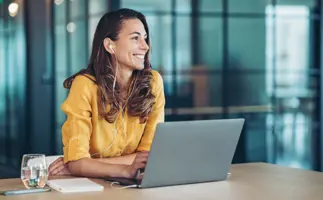 Woman smiling. Representing the treasury eLearning First Steps in Treasury course